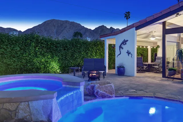 a view of a porch with furniture and a garden