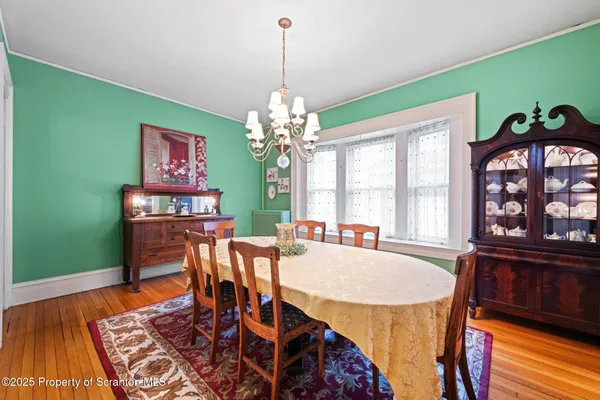 a dining room with furniture a rug and wooden floor