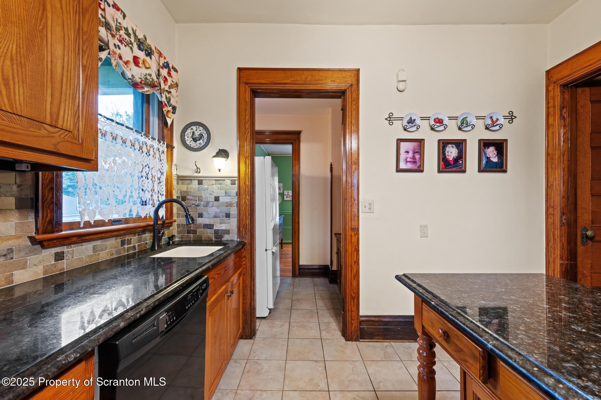 1012 Sunset Street Scranton, PA 18509 - Photo 19 of 46 a kitchen with stainless steel appliances granite countertop a stove and a sink
