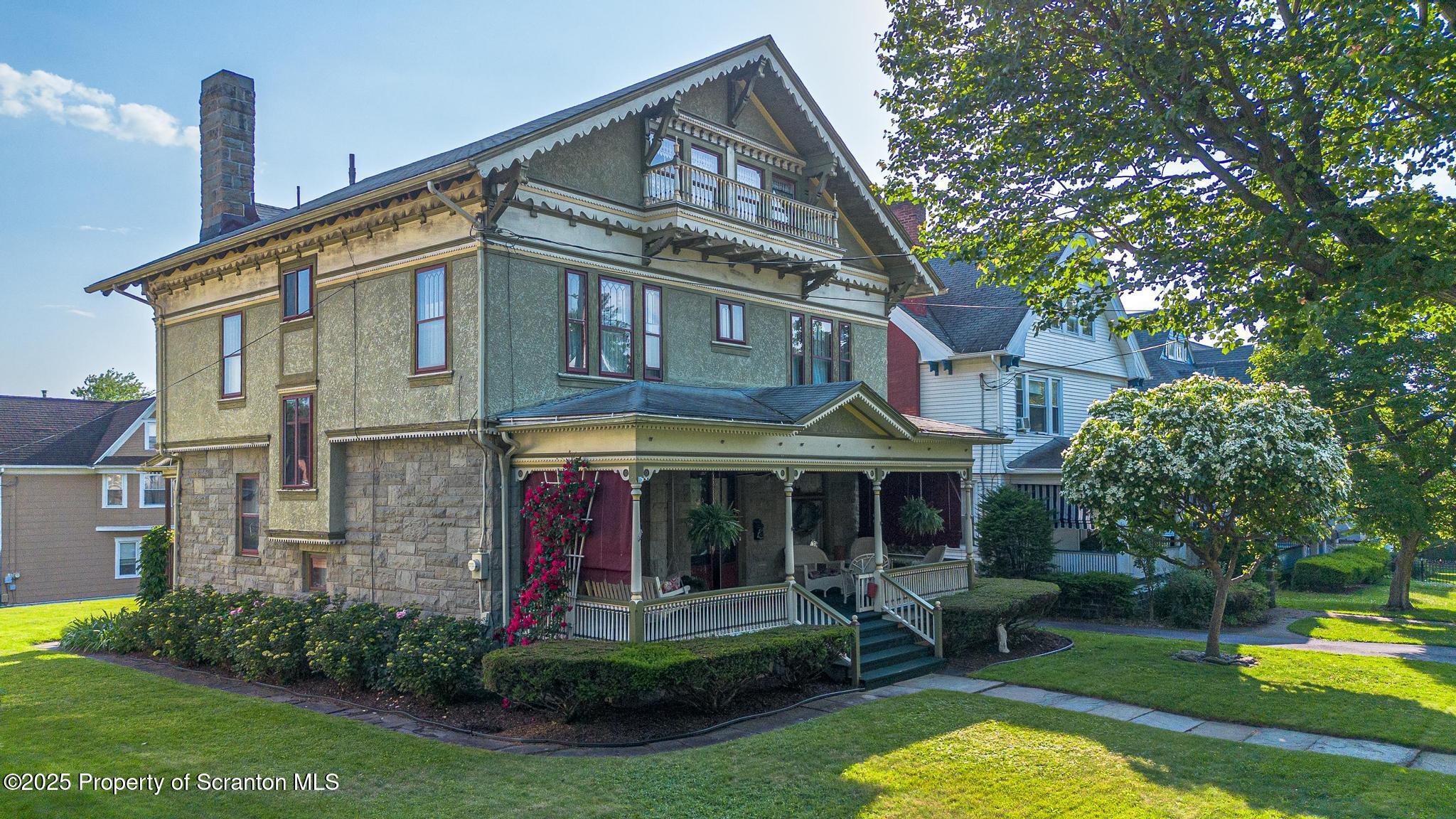 1012 Sunset Street Scranton, PA 18509 - Photo 2 of 46 a front view of a house with a yard table and chairs