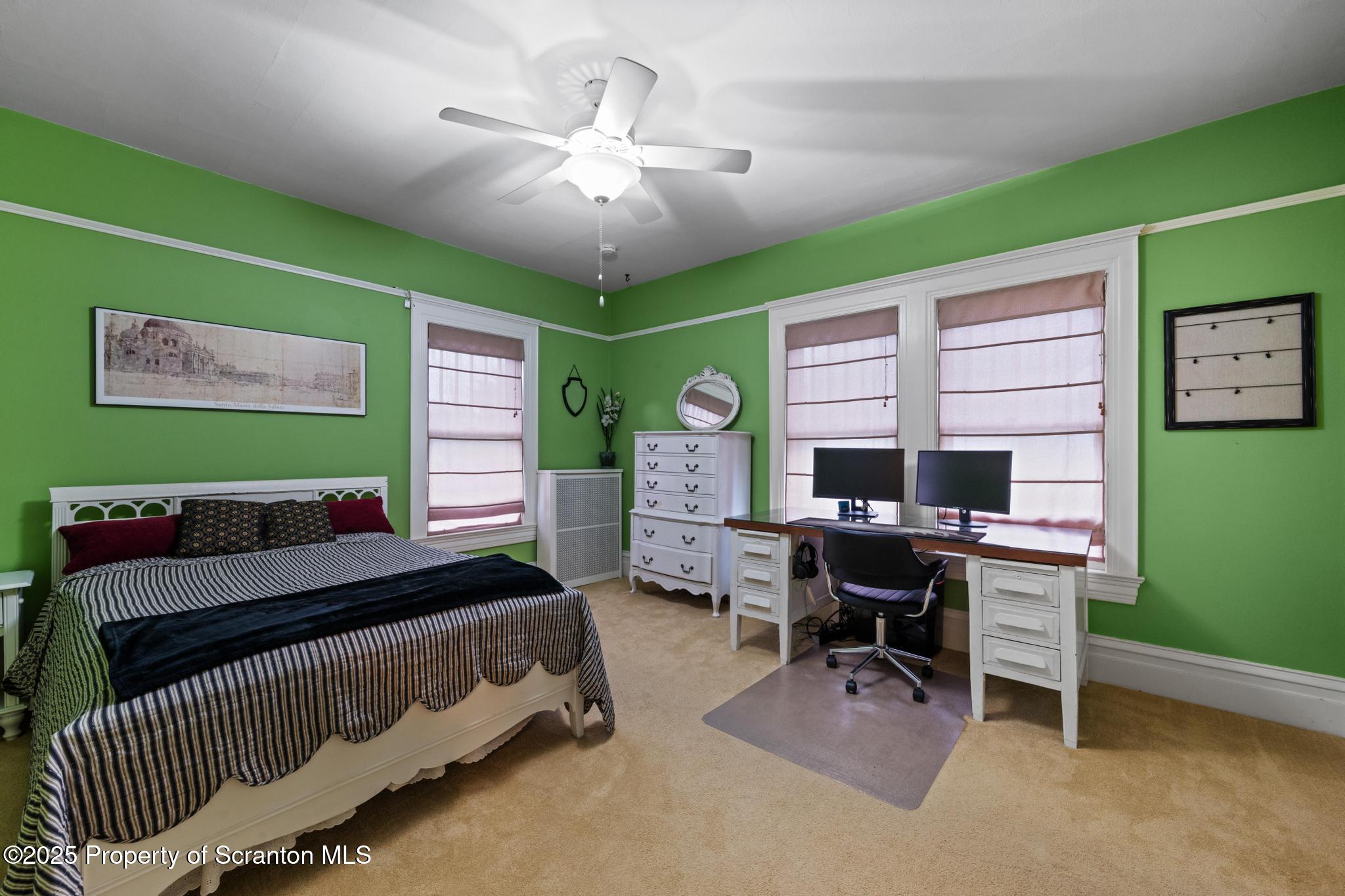 1012 Sunset Street Scranton, PA 18509 - Photo 23 of 46 a bedroom with a large window and a chandelier