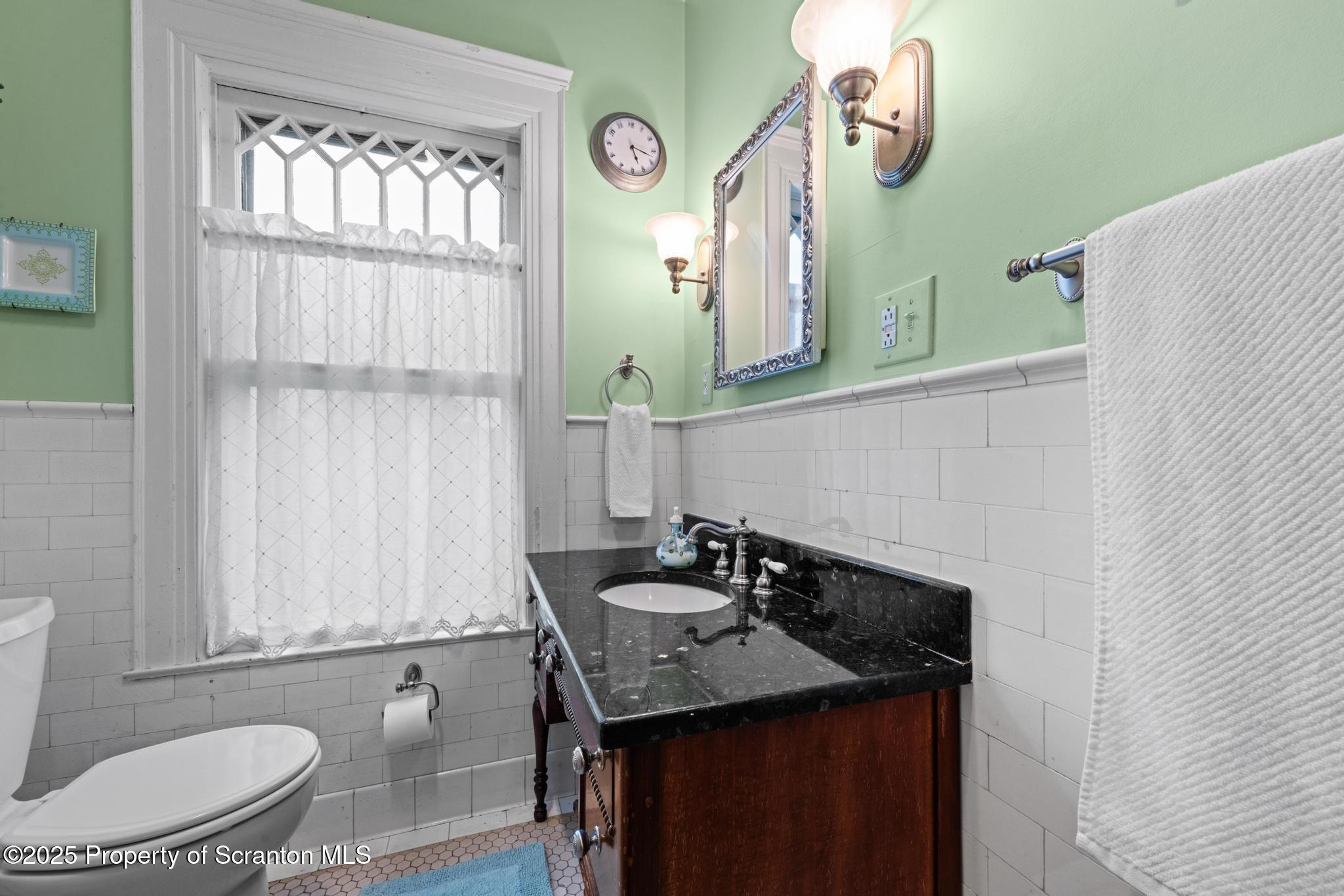 1012 Sunset Street Scranton, PA 18509 - Photo 26 of 46 a bathroom with a sink a toilet and mirror