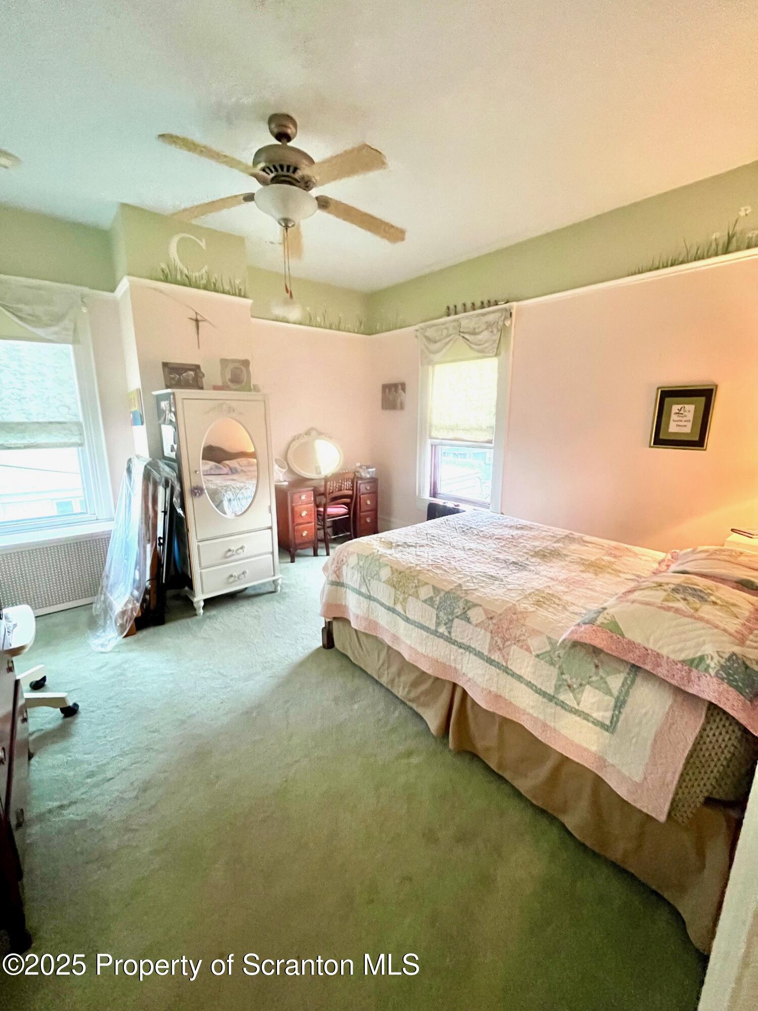 1012 Sunset Street Scranton, PA 18509 - Photo 28 of 46 a spacious bedroom with a bed and a chandelier