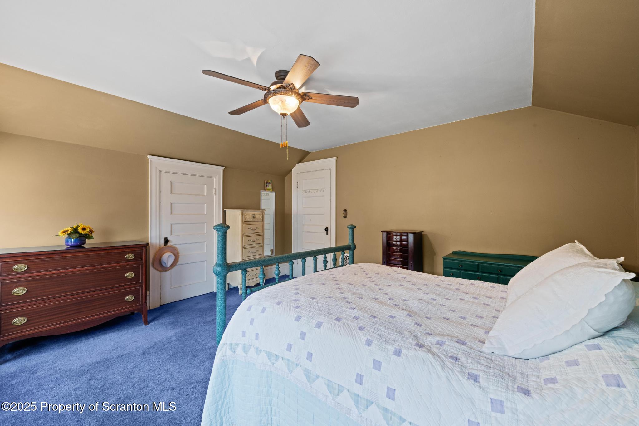 1012 Sunset Street Scranton, PA 18509 - Photo 30 of 46 a bedroom with a bed and a chandelier