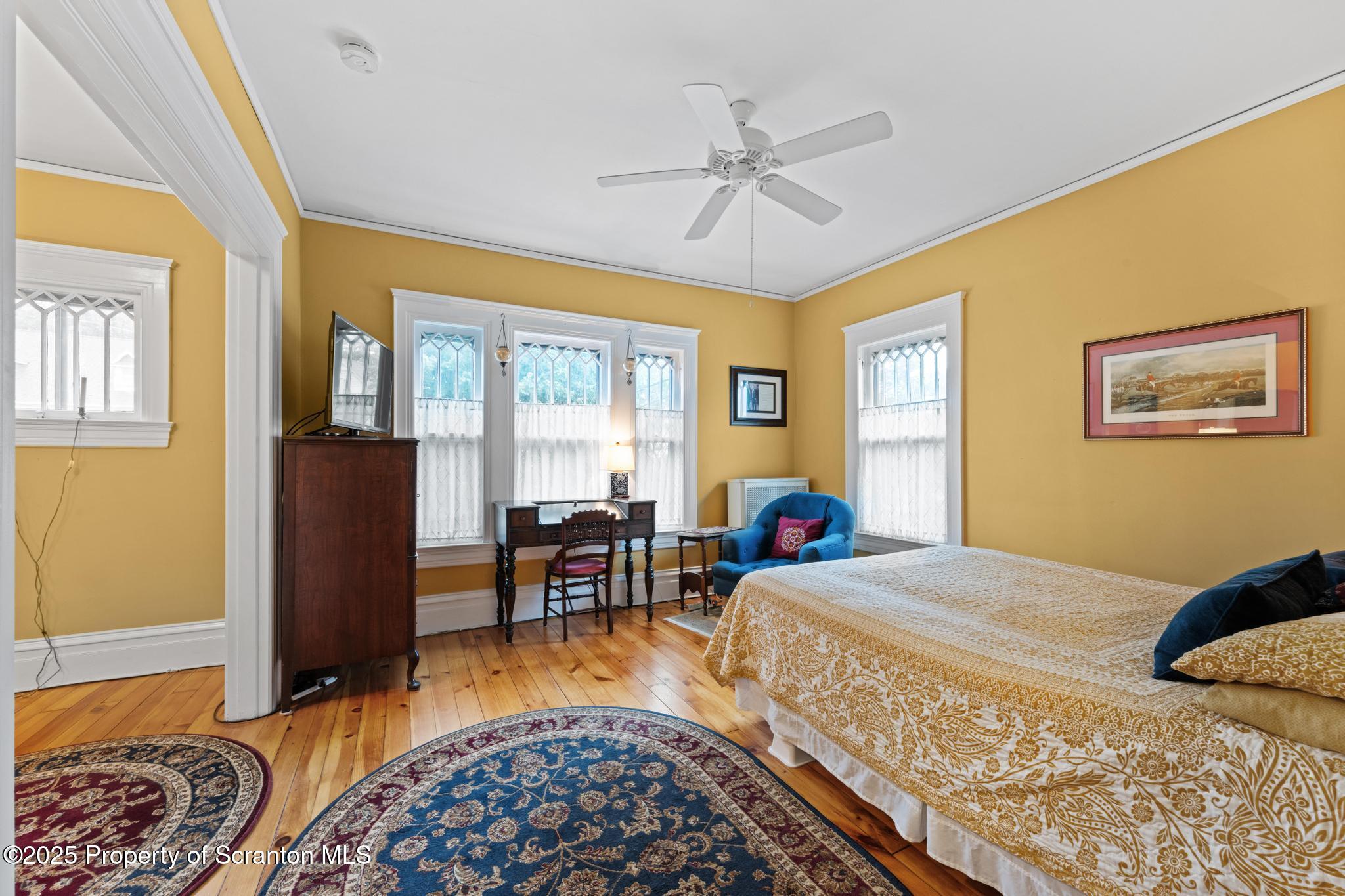 1012 Sunset Street Scranton, PA 18509 - Photo 31 of 46 a bedroom with a bed and wooden floor