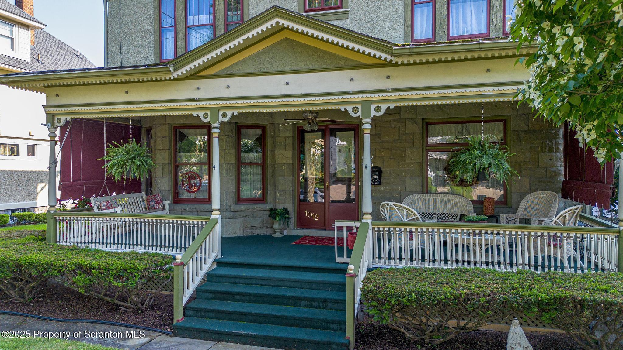 1012 Sunset Street Scranton, PA 18509 - Photo 39 of 46 a view of a house with a small yard and a large tree