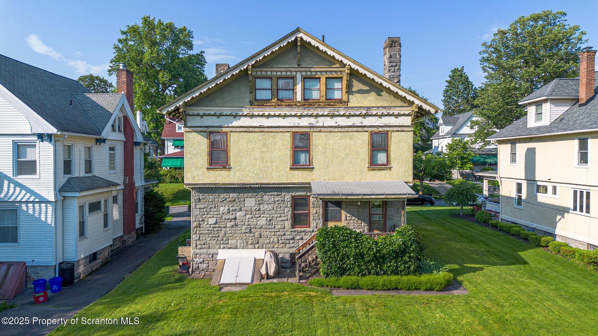 1012 Sunset Street Scranton, PA 18509 - Photo 41 of 46 a front view of a house with a yard and garage