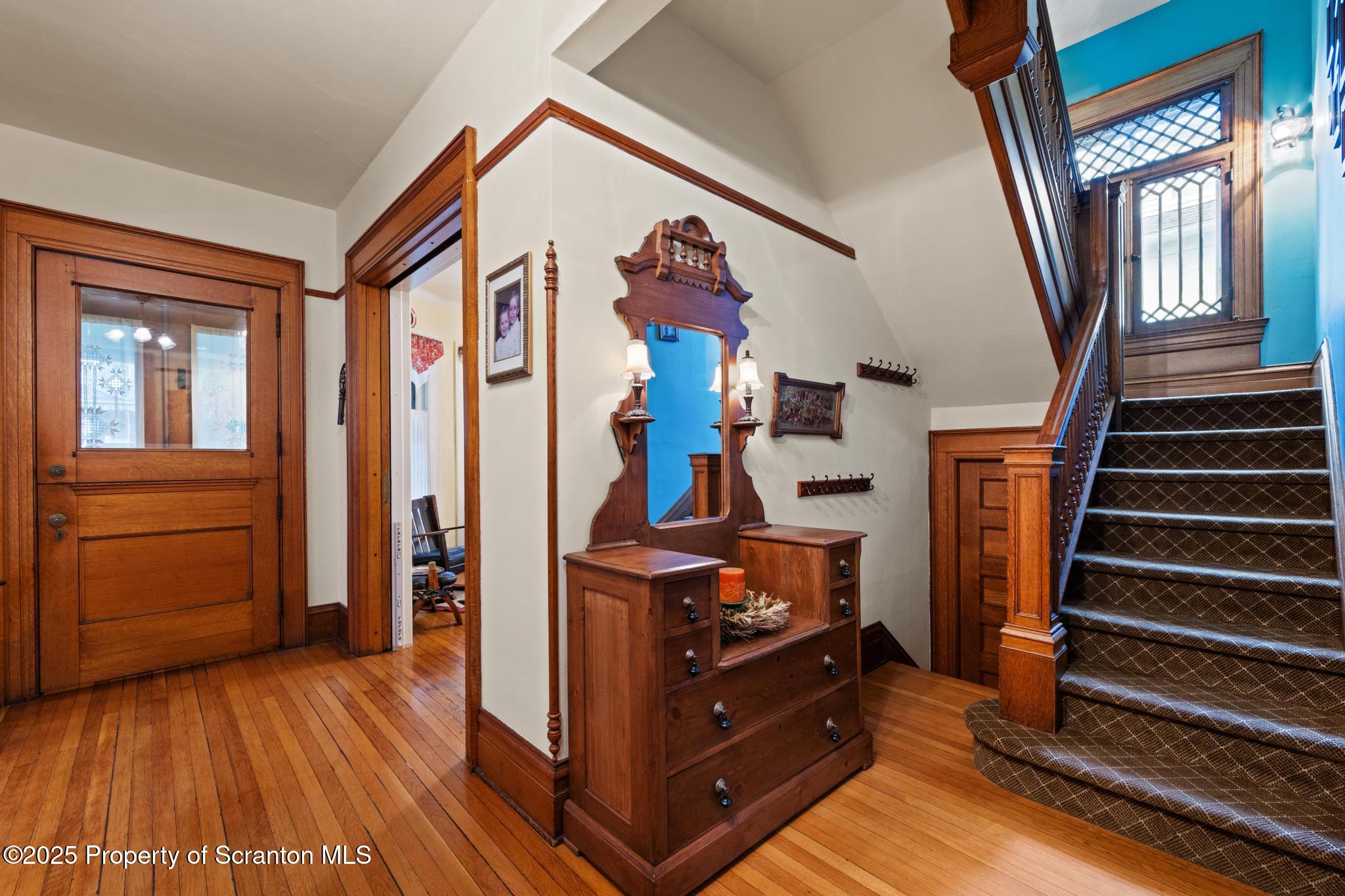 1012 Sunset Street Scranton, PA 18509 - Photo 5 of 46 a view of a hallway with wooden floor and staircase
