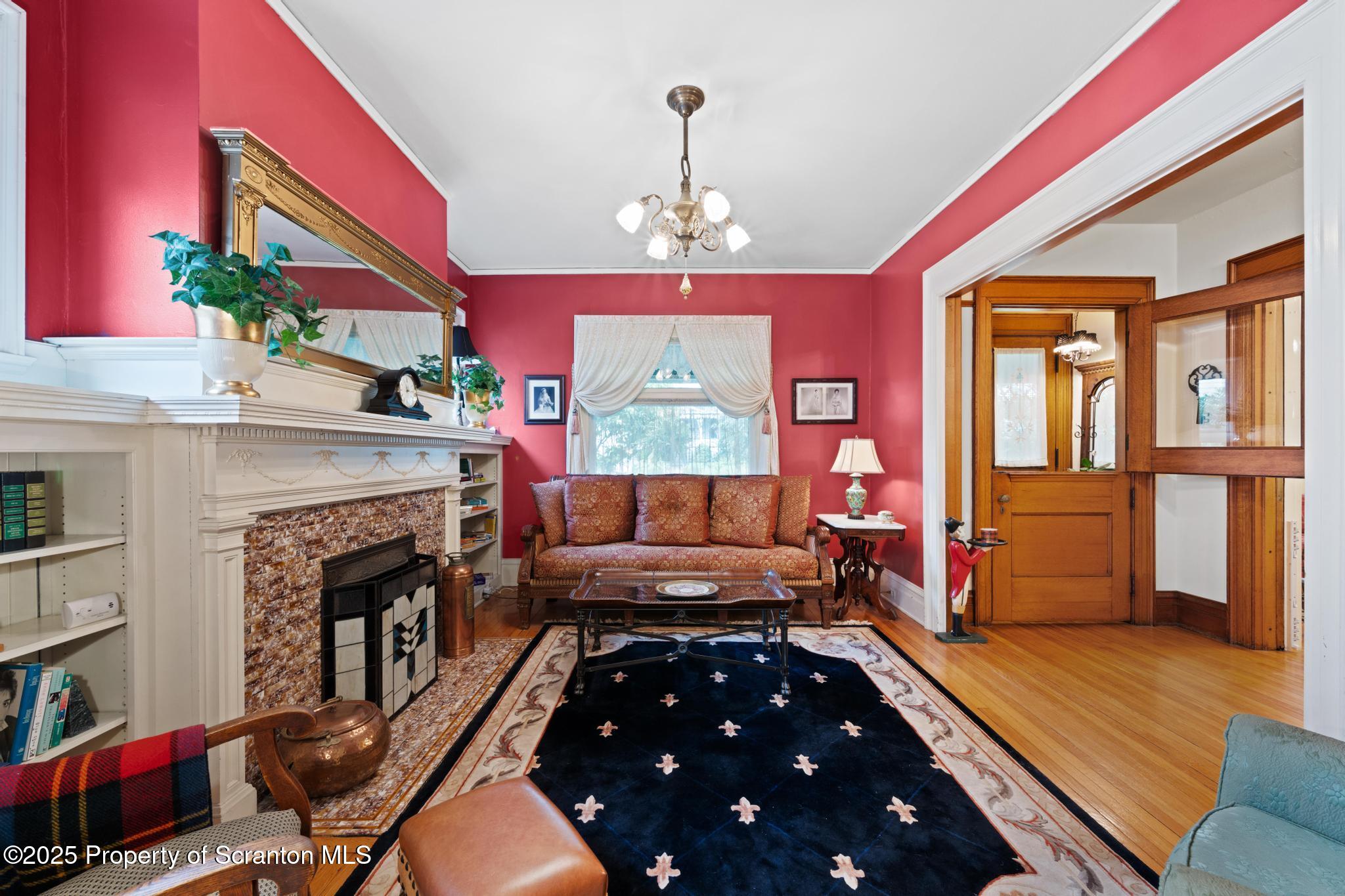 1012 Sunset Street Scranton, PA 18509 - Photo 7 of 46 a living room with furniture fireplace and flat screen tv