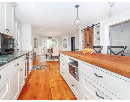 29 Gate House Road Newton, MA 02467 - Photo 13 of 29 a large kitchen with kitchen island a large counter top space a sink stainless steel appliances and cabinets