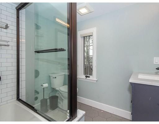 a bathroom with a shower and toilet