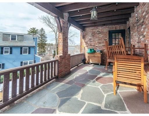 a view of a porch with wooden floor and iron stairs