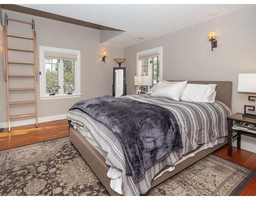 a spacious bedroom with a bed and a window