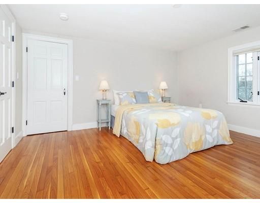 a bedroom with a bed and a wooden floor