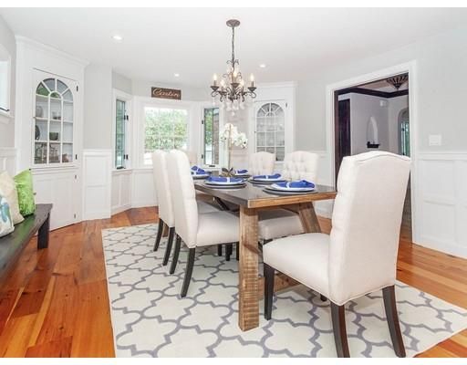 a dining room with furniture a rug and wooden floor