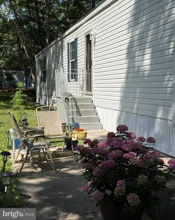 a view of a chairs and table in backyard