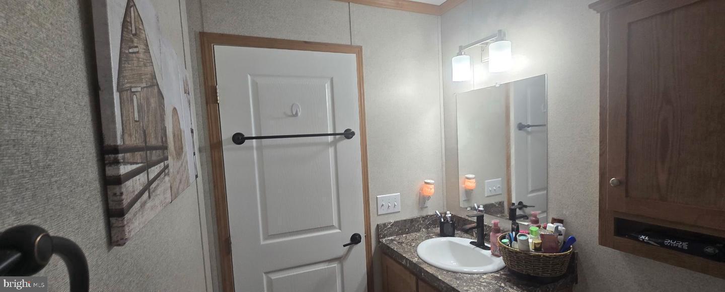 2110 Mays Landing Road, Unit 73 Millville, NJ 08332 - Photo 11 of 11 a bathroom with a sink and a mirror