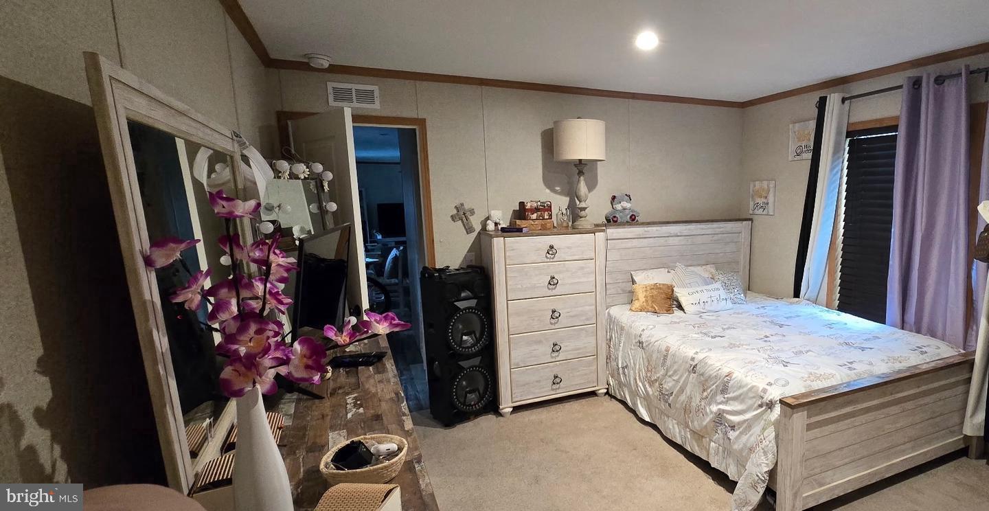 2110 Mays Landing Road, Unit 73 Millville, NJ 08332 - Photo 10 of 11 a bedroom with a bed and a mirror