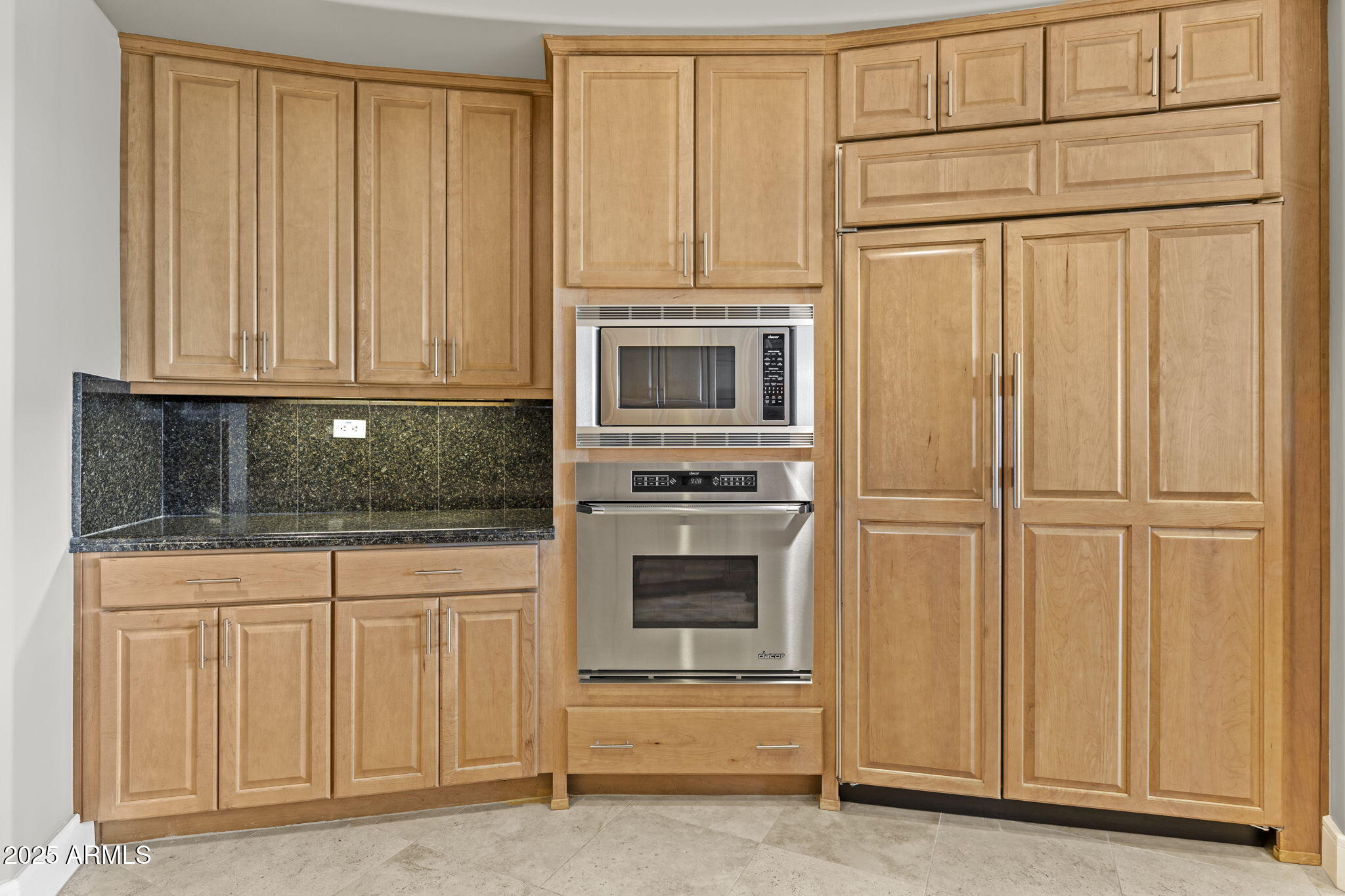2211 East Camelback Road, Unit 201 Phoenix, AZ 85016 - Photo 12 of 42 a kitchen with granite countertop white cabinets and stainless steel appliances
