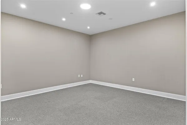 a living room with furniture a rug and white walls