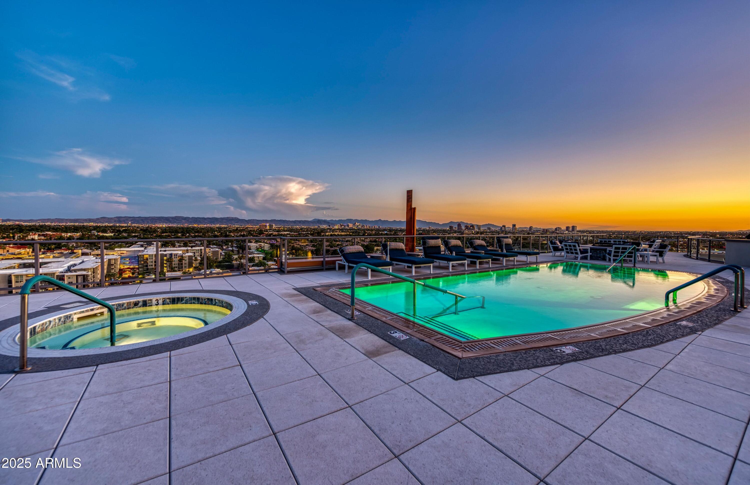 2211 East Camelback Road, Unit 201 Phoenix, AZ 85016 - Photo 36 of 42 a view of a swimming pool with an outdoor seating