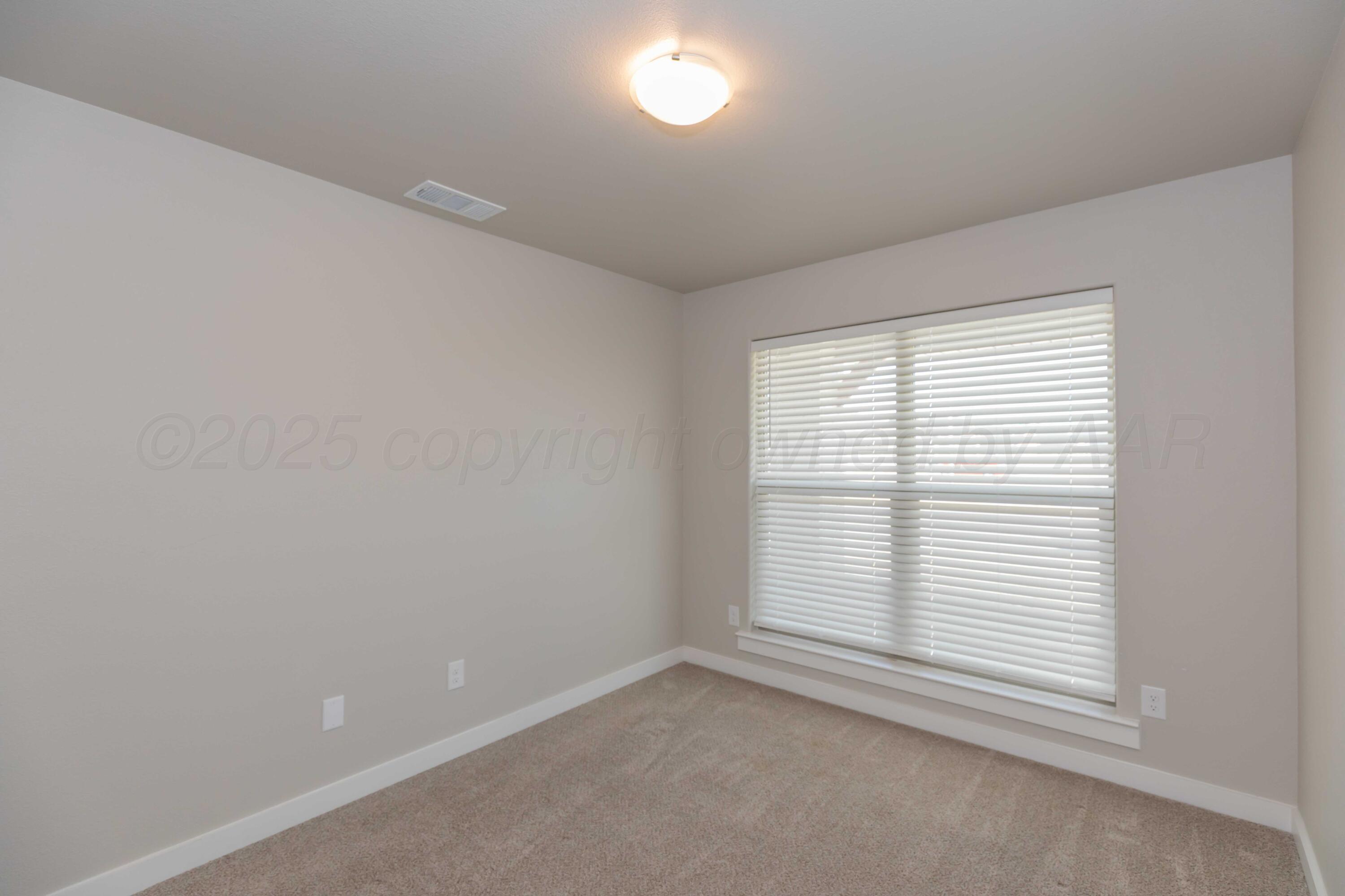 1801 Moon River Road Amarillo, TX 79118 - Photo 17 of 43 an empty room with a window