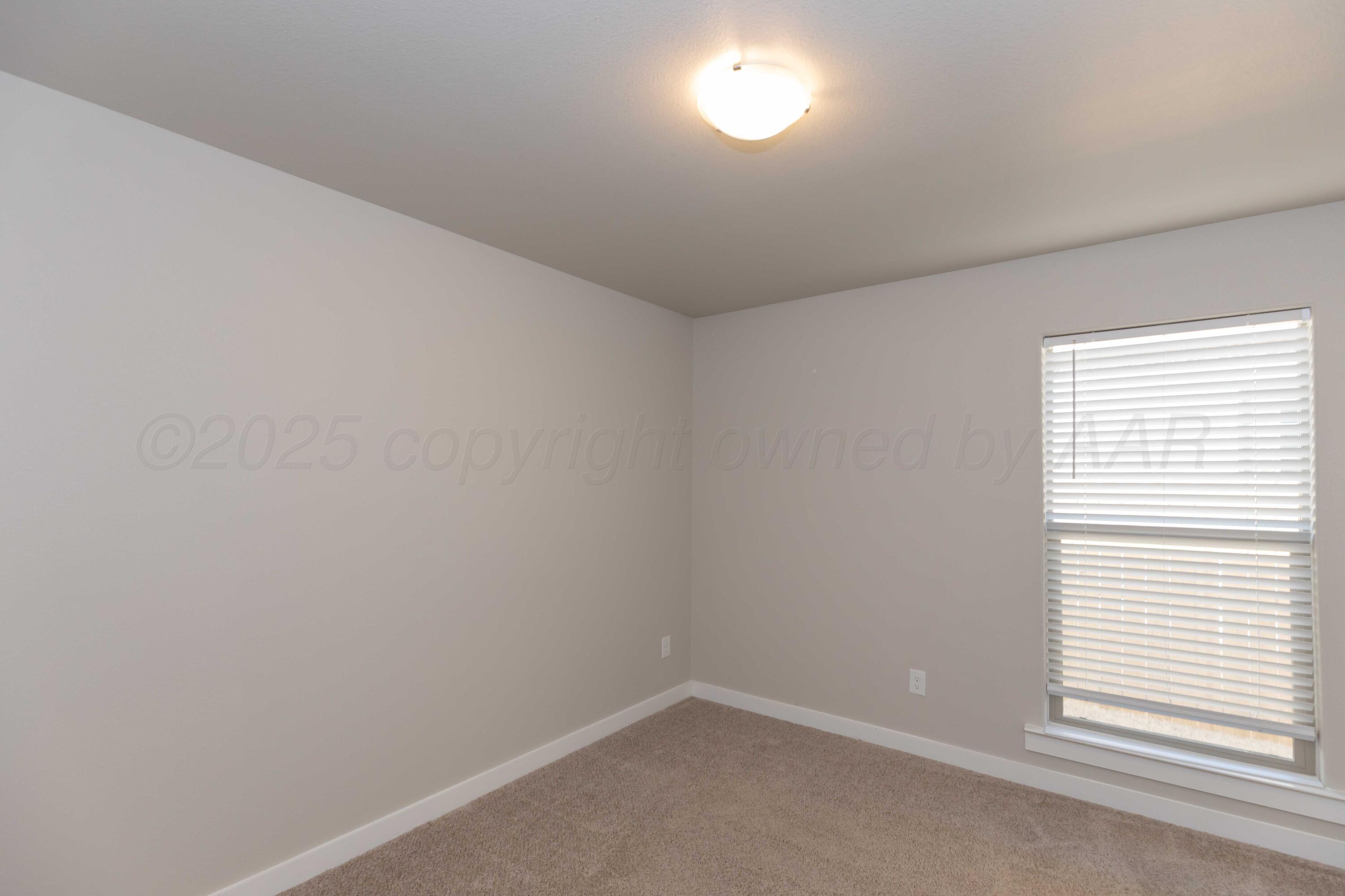 1801 Moon River Road Amarillo, TX 79118 - Photo 18 of 43 an empty room with a window