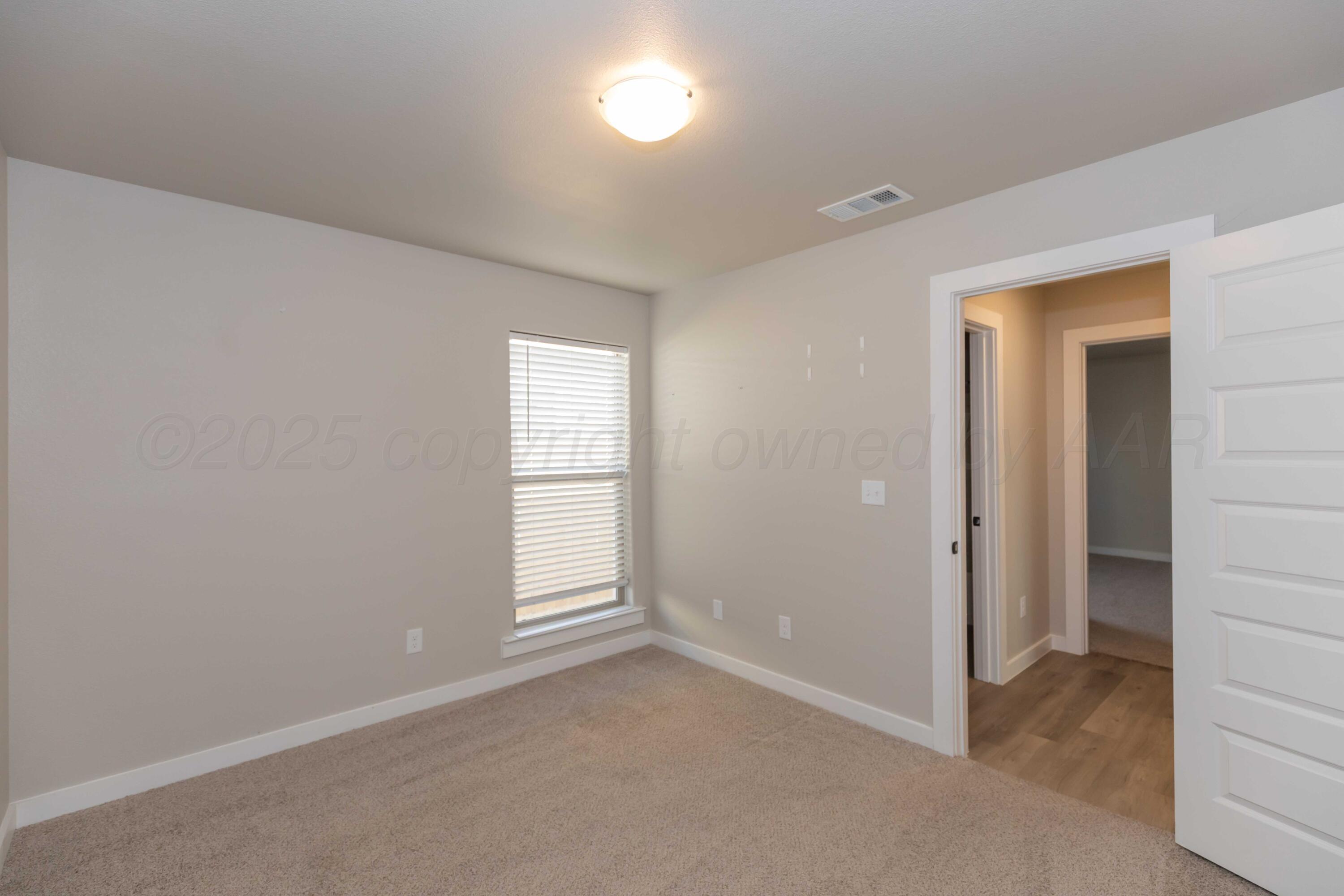 1801 Moon River Road Amarillo, TX 79118 - Photo 19 of 43 an empty room with windows and closet