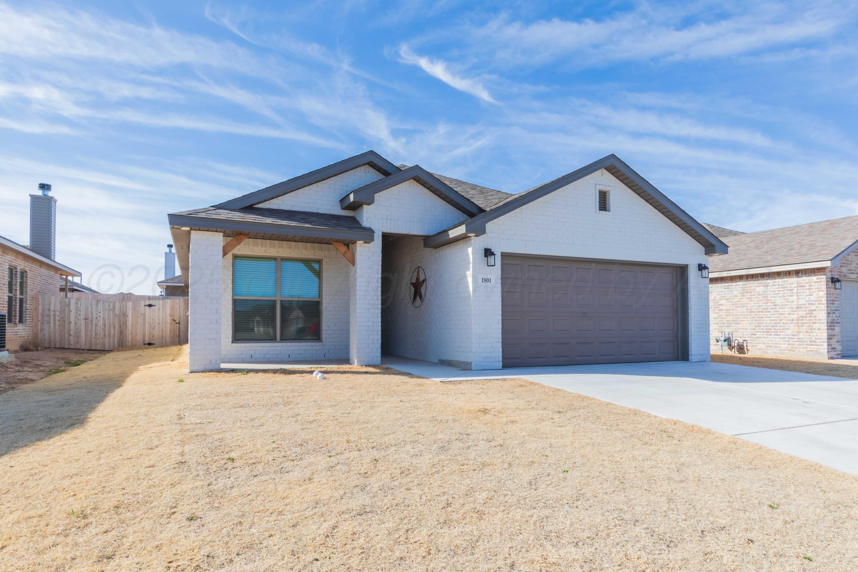 1801 Moon River Road Amarillo, TX 79118 - Photo 2 of 43 a front view of a house with a yard and garage