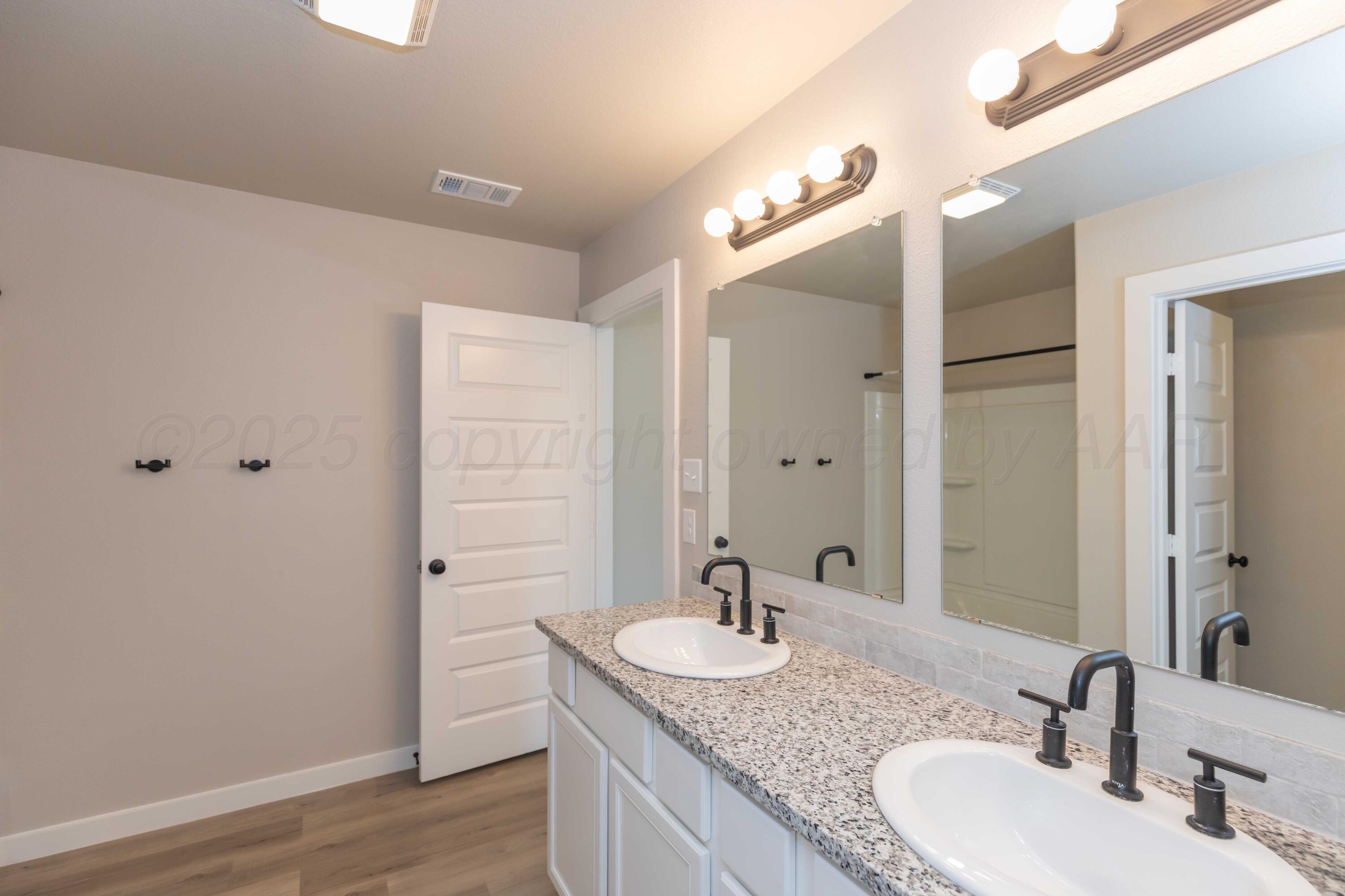 1801 Moon River Road Amarillo, TX 79118 - Photo 33 of 43 a bathroom with a granite countertop sink and a mirror