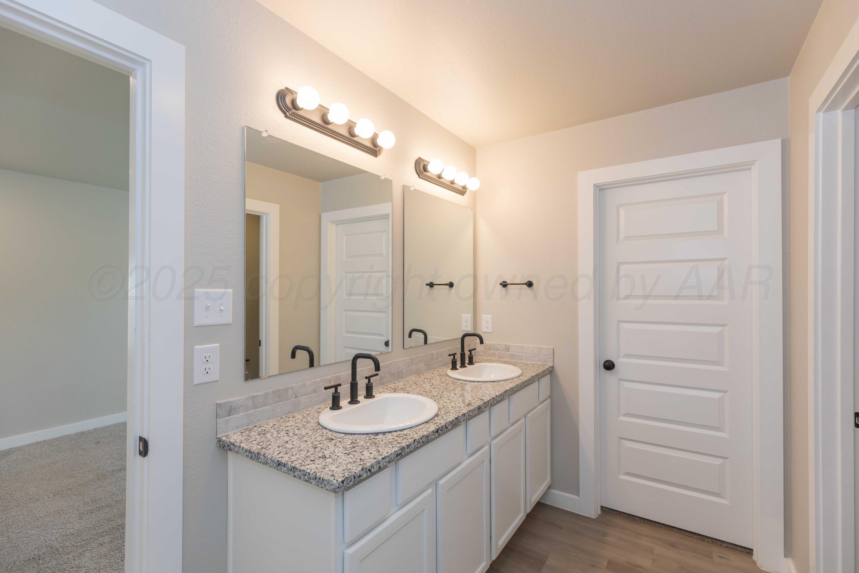 1801 Moon River Road Amarillo, TX 79118 - Photo 35 of 43 a bathroom with a granite countertop sink and a mirror