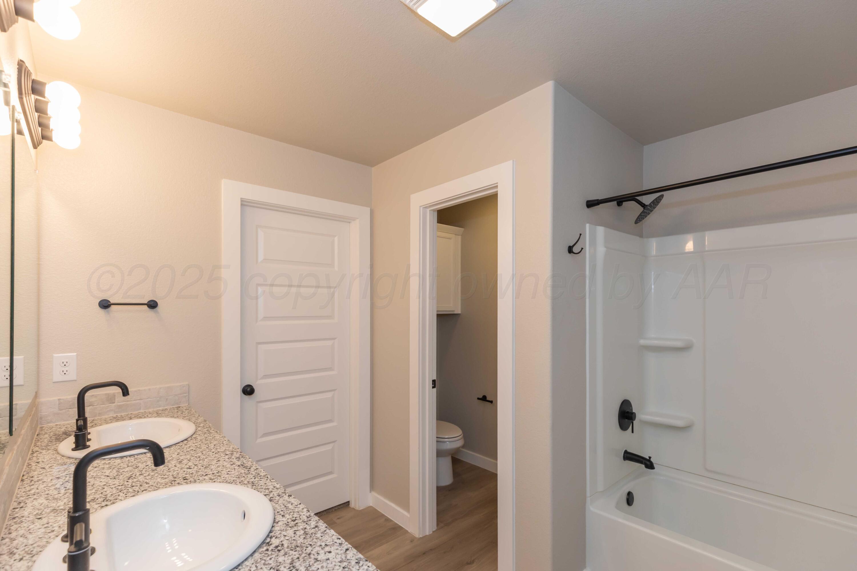 1801 Moon River Road Amarillo, TX 79118 - Photo 36 of 43 a bathroom with a sink toilet and shower