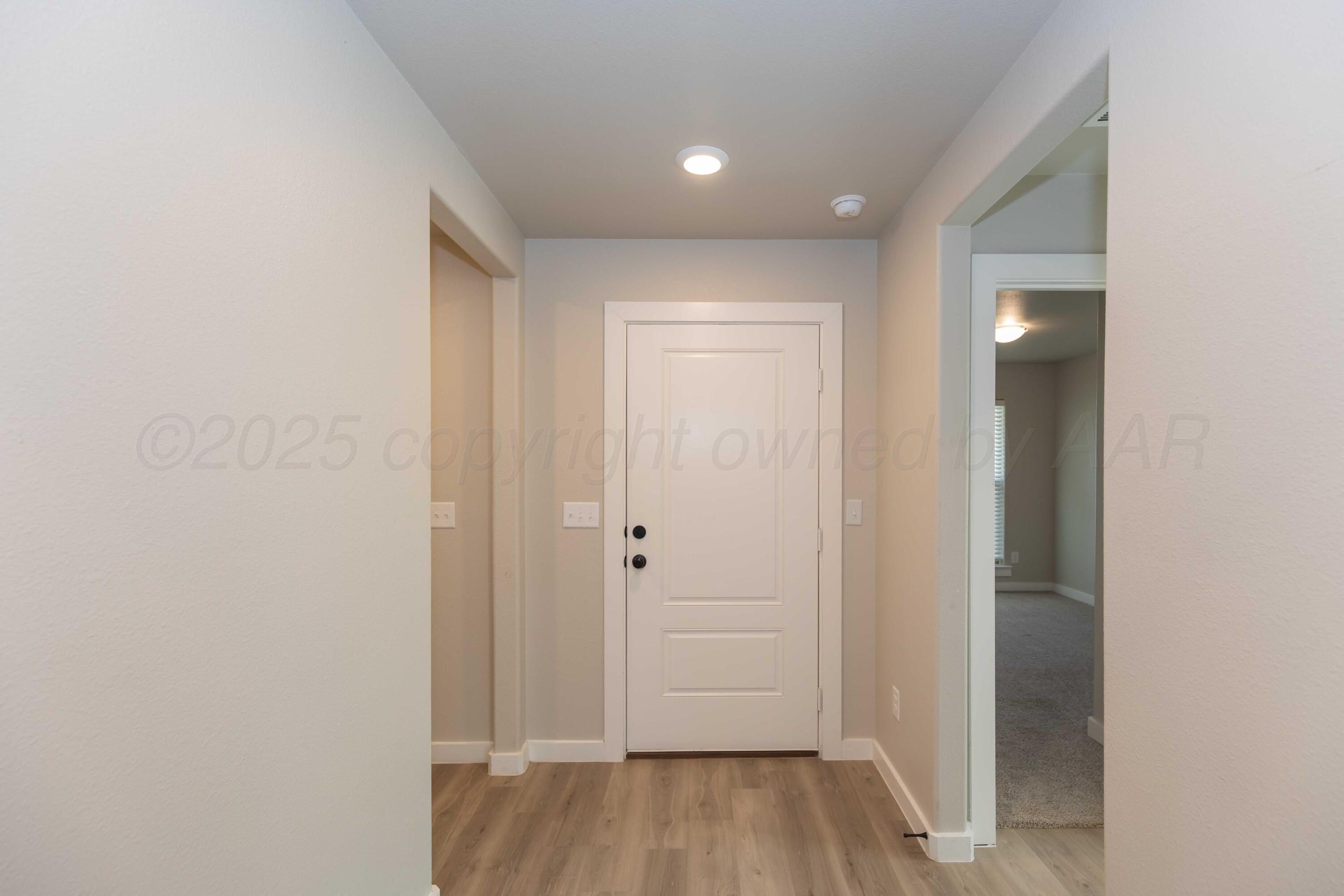 1801 Moon River Road Amarillo, TX 79118 - Photo 4 of 43 a view of a hallway with wooden floor