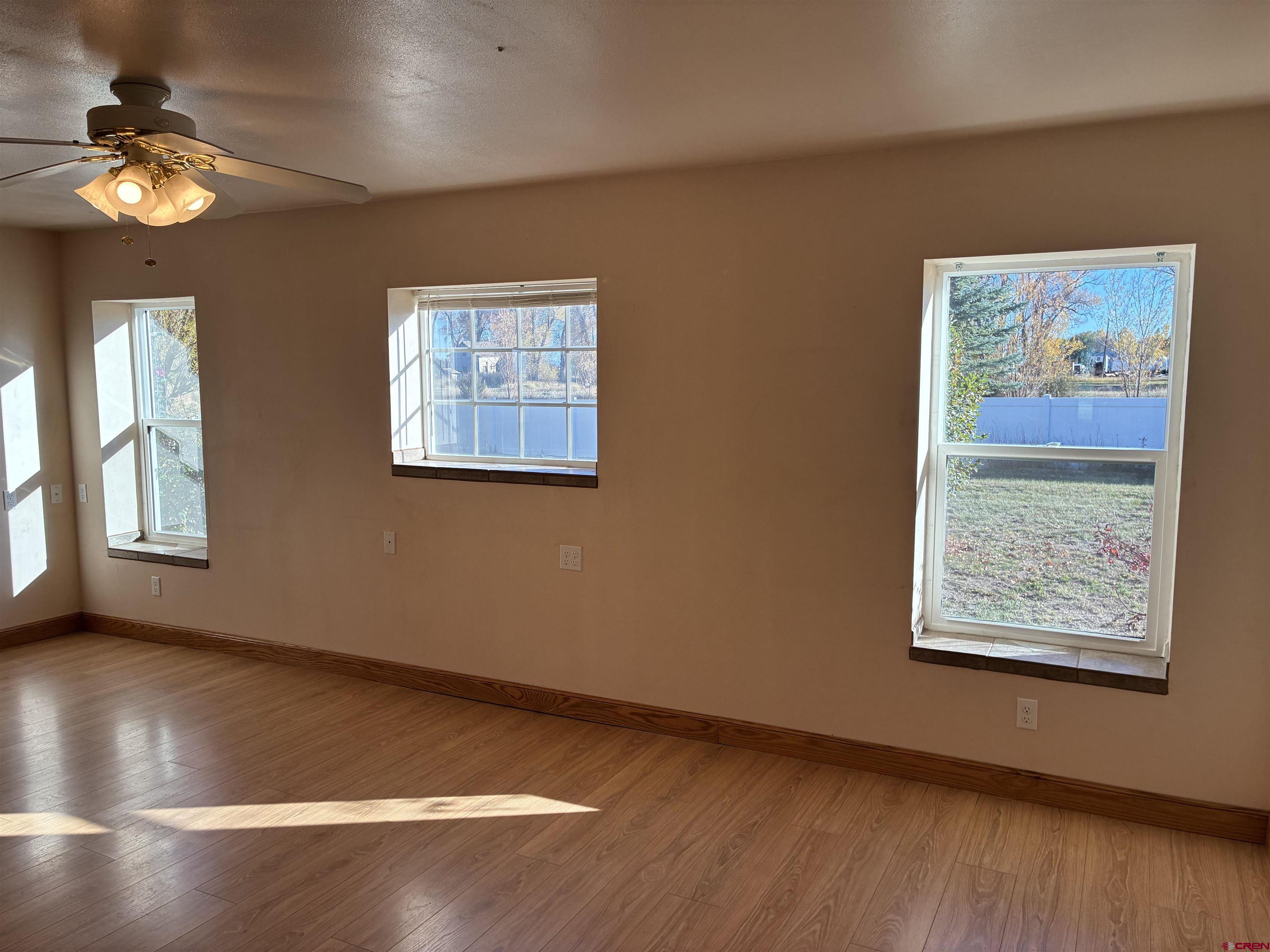 15334 County Rd T.5 La Jara, CO 81140 - Photo 23 of 28 a view of an empty room with window and wooden floor