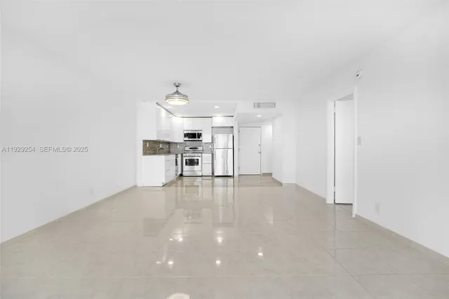 a kitchen with stainless steel appliances a refrigerator and a stove top oven