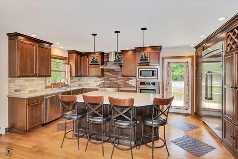a dining table with chairs and cabinets