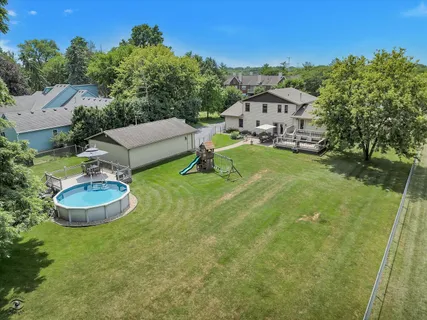 an aerial view of a house with outdoor space pool patio and outdoor seating