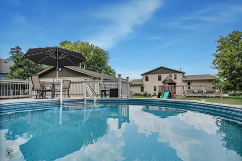 a balcony with table and chairs