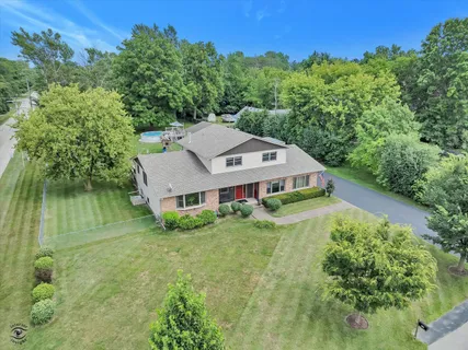 an aerial view of a house with a yard