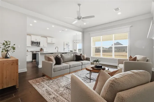 a living room with furniture and a large window