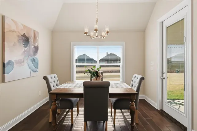 a view of a dining room with furniture large windows and wooden floor