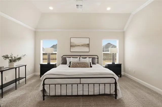 a bedroom with a large bed and a painting on the wall