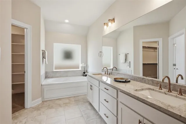 a spacious bathroom with a double vanity sink and a mirror