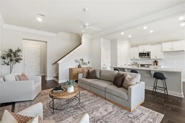 a living room with furniture kitchen and a table