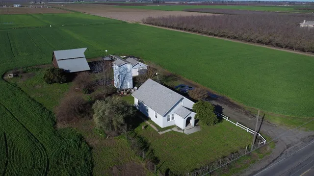an aerial view of a house with a yard