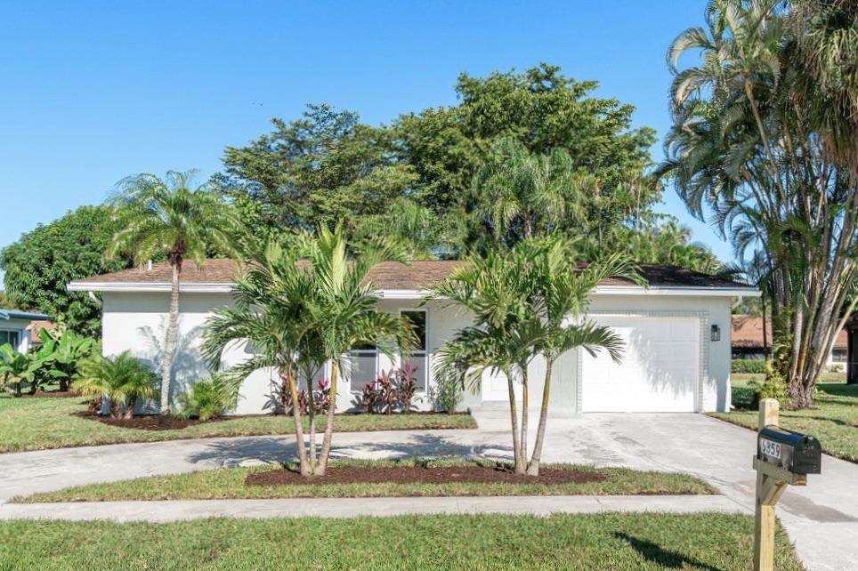 6359 Winding Brook Way Delray Beach, FL 33484 - Photo 1 of 24 a front view of house with yard and green space