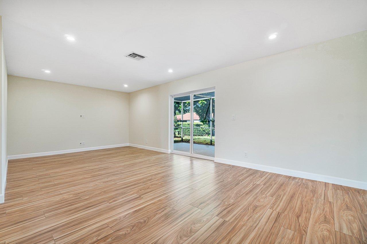 6359 Winding Brook Way Delray Beach, FL 33484 - Photo 10 of 24 an empty room with wooden floor and windows