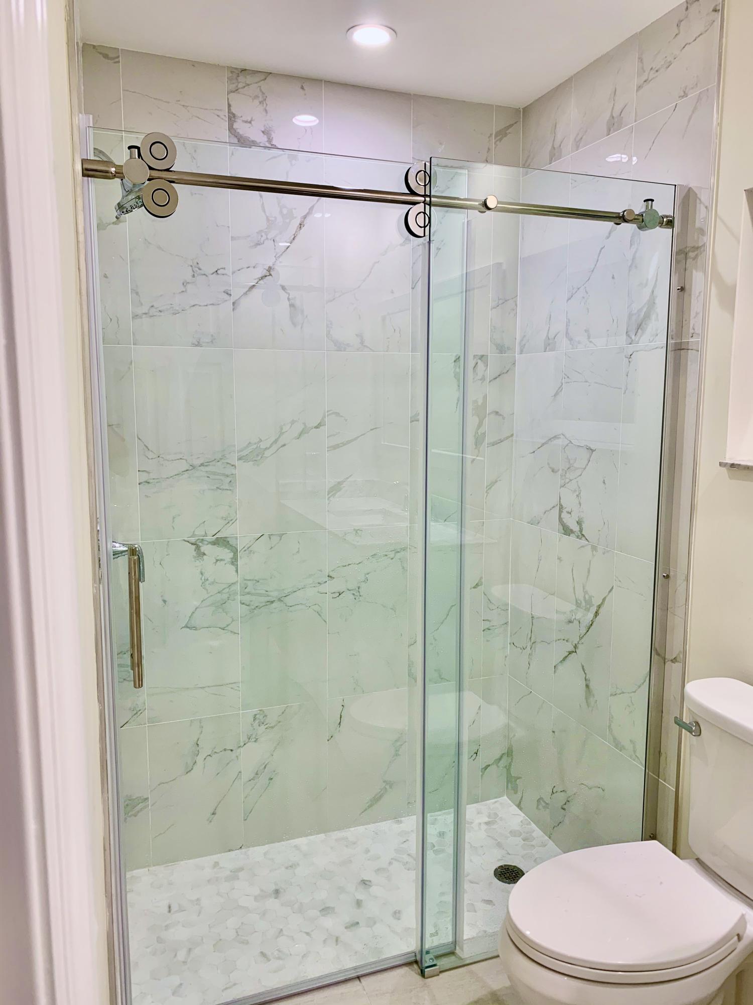 6359 Winding Brook Way Delray Beach, FL 33484 - Photo 14 of 24 a bathroom with a shower and a toilet