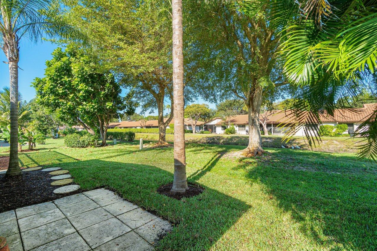 6359 Winding Brook Way Delray Beach, FL 33484 - Photo 17 of 24 a view of a garden with a tree