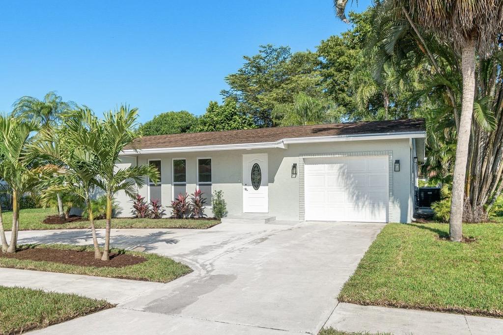 6359 Winding Brook Way Delray Beach, FL 33484 - Photo 2 of 24 a front view of a house with a yard and potted plants